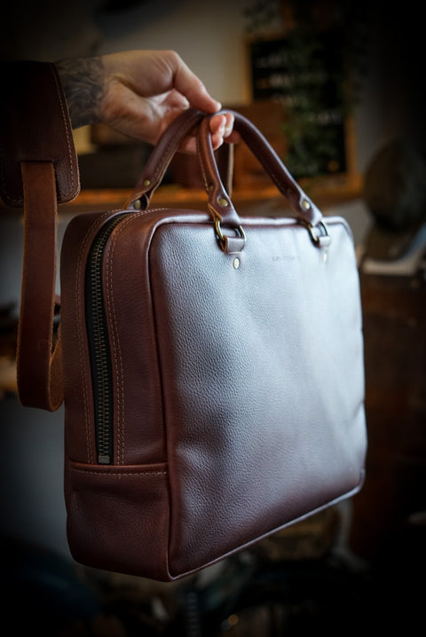 Full grain pebbled brown leather business bag handmade in canada with brush brass hardware and removable shoulder strap